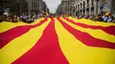 Sejumlah orang mengarak bendera Catalonia raksasa ketika merayakan Hari Nasional Spanyol di jalanan Barcelona, Kamis (12/10). Hari Nasional sendiri memperingati kedatangan pertama Christopher Columbus di Amerika pada tahun 1492. (AP / Santi Palacios)