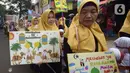 Orangtua murid TK Islam berjalan bersama sambil membawa poster di Jalan Raya Radjiman Widyo Ningrat, Jakarta, Sabtu (26/3/2022). Pemerintah telah memperbolehkan melaksanakan kewajiban selama bulan suci Ramadan dengan protokol kesehatan yang ketat. (merdeka.com/Imam Buhori)