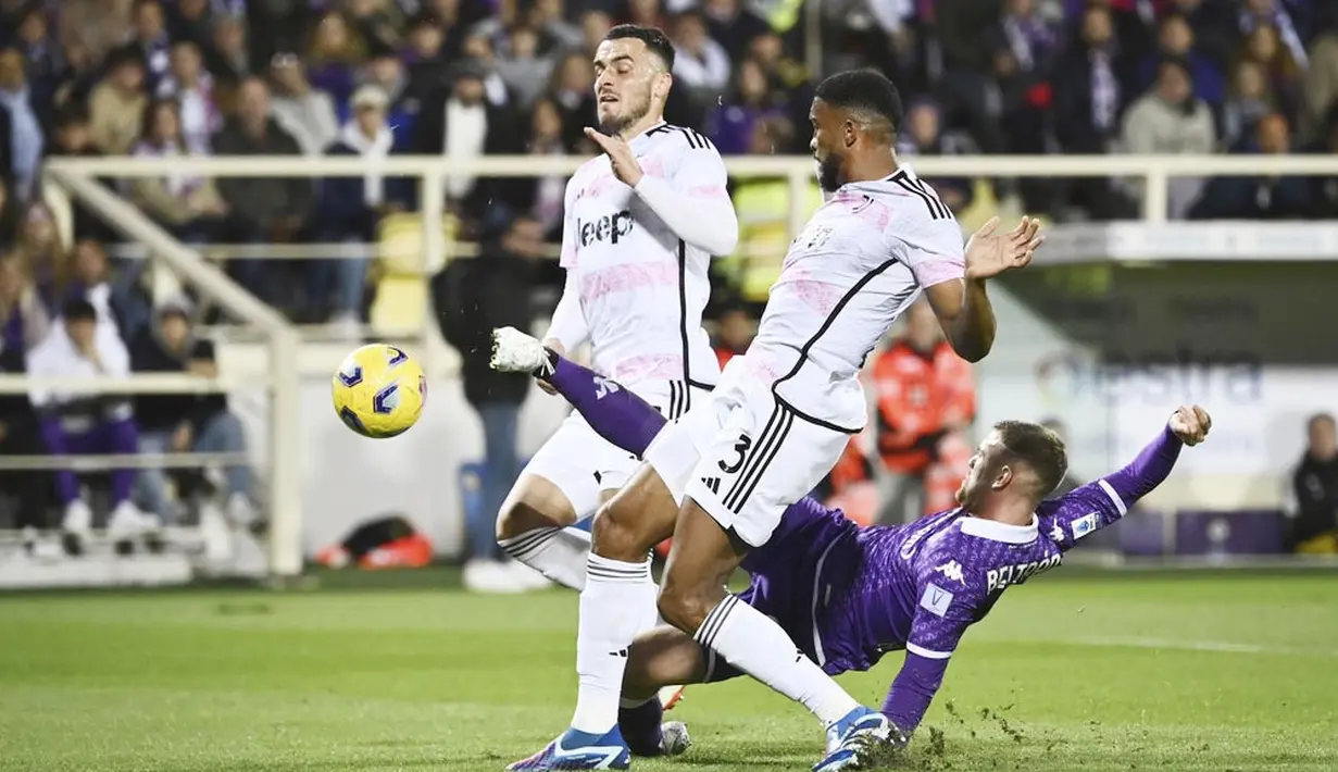 Pemain Juventus, Filip Kostic, berusaha menghalau tendangan pemain Fiorentina, Lucas Beltran, pada laga Liga Italia di Stadion Artemio Franchi, Senin (06/11/2023). (LaPresse via AP/Massimo Paolone)