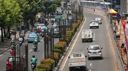 Sejumlah kendaraan melaju di antara tiang beton proyek monorel di Jalan HR Rasuna Said, Jakarta, Selasa (4/9). Pada tahap pertama, ERP atau jalan berbayar akan berlaku di Sudirman dan Jalan HR. Rasuna Said pada Maret 2019. (Liputan6.com/Faizal Fanani)