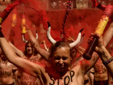 Sejumlah aktivis berunjuk rasa memprotes adu banteng dalam Festival San Fermin di depan Balai Kota di Pamplona, Spanyol utara, (5/7). Festival San Fermin dimulai pada 6 Juli dengan Txupinazo atau seremoni. (AP Photo/Alvaro Barrientos)