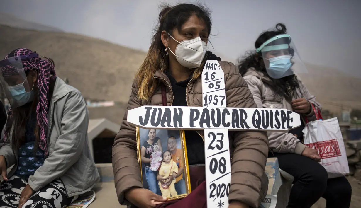 Ruth Morales (36) menunggu kedatangan peti mati suaminya, Juan Paucar Quispe (63), yang meninggal karena komplikasi COVID-19 saat pemakaman di Carabayllo, Lima, Peru, Selasa (25/8/2020). Total kasus COVID-19 di Peru mencapai 600 ribu dengan 407 ribu sembuh dan 27.813 wafat. (AP Photo/Rodrigo Abd)