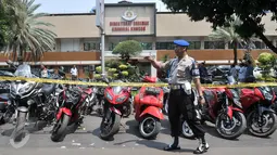 Petugas Kepolisian berjaga di depan barang bukti sitaan kasus dugaan penipuan, penggelapan dan tindak pidana pencucian uang (TPPU) Pandawa Group di Polda Metro, Jakarta, Kamis (9/3). (Liputan6.com/Yoppy Renato)