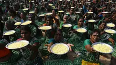 Para wanita membawa bunga persembahan dalam upacara penghormatan untuk korban tsunami tahun 2004 di Pantai Pattinapakkam, Chennai, India, Rabu (26/12). Lebih dari 10 ribu warga India tewas dalam tsunami Samudra Hindia pada 2004 lalu. (ARUN SANKAR/AFP)