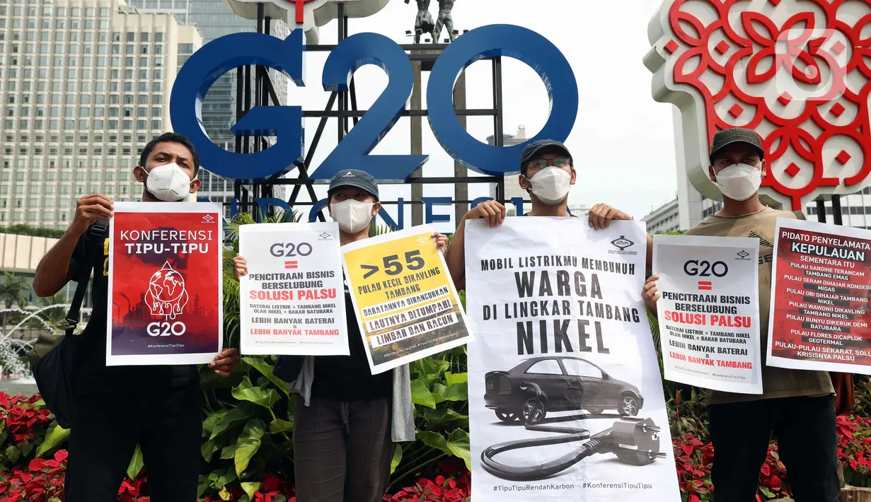 Aktivis iklim membawa sejumlah poster saat melakukan aksi teatrikal di kawasan Bundaran Hotel Indonesia, Jakarta, Minggu (13/11/2022). Aksi yang digelar berbarengan dengan penyelenggaraan G20 ini meminta pemimpin dunia menemukan solusi bersama atas kondisi ekonomi global. (Liputan6.com/Herman Zakharia)
