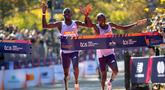 Pelari Kenya, Benson Kipruto (kiri) dan kompatriotnya, Alexander Mutiso melintasi garis finis pada ajang New York Marathon 2025 pada Minggu (02/11/2025) waktu setempat. Ini menjadi finis dengan jarak terdekat dalam ajang maraton dengan selisih 0,03 detik. (AP Photo/Angelina Katsanis)