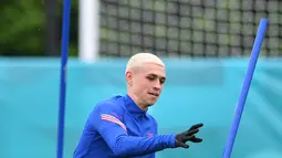 Gelandang Inggris, Phil Foden melakukan pemanasan saat mengikuti latihan di Tottenham Hotspur training di London (21/6/2021). Inggris dan Republik Ceko sebenarnya hanya membutuhkan hasil imbang saat bertemu di laga terakhir Grup D Euro 2020,. (AFP/Justin Tallis)