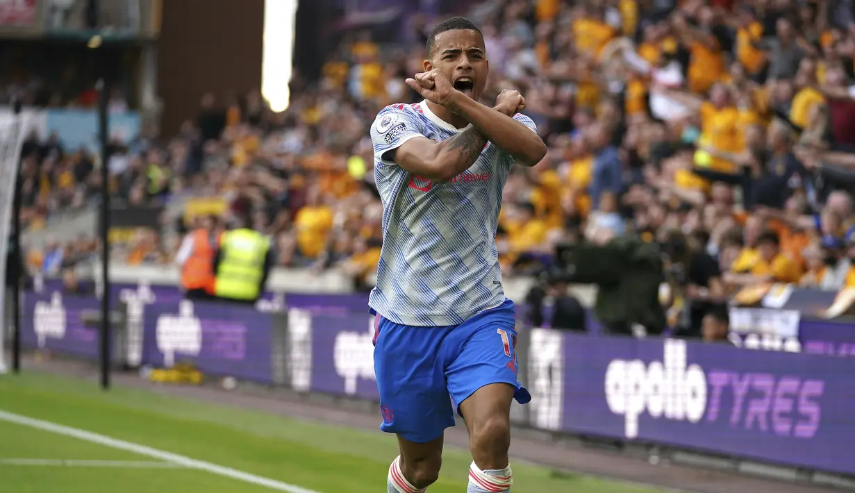 Penyerang Manchester United (MU) Mason Greenwood merayakan gol yang dicetaknya ke gawang Wolverhampton Wanderers pada match day ketiga Liga Inggris di Stadion Molineux, Minggu (29/8/2021). MU menang tipis 1-0 lewat gol Mason Greenwood. (Nick Potts/PA via AP)
