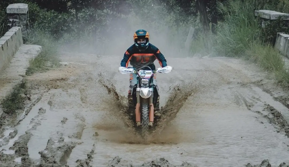 Gaya keren presenter sekaligus komedian ini saat motor menerabas genangan air. Wajahnya terlihat bahagia saat tengah menikmati hobi yang cukup ekstrem ini. (Liputan6.com/IG/@bilsky16)