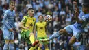 Bek Manchester City, Joao Cancelo berebut bola dengan gelandang Norwich City, Billy Gilmour pada pertandingan pekan kedua Liga Inggris di stadion Etihad di Manchester, Inggris, Sabtu (21/8/2021). Man City menang telak atas Norwich City 5-0. (AP Photo/Rui Vieira)