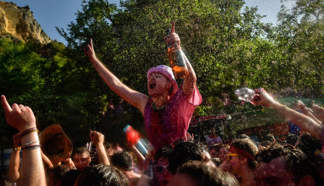 Orang-orang bersuka ria dalam perang anggur di Haro, Spanyol utara, Sabtu (29/6/2019). Setiap peserta wajib mengenakan pakaian putih pada festival yang diselenggarakan rutin setiap bulan Juni di kota Haro, yang terkenal sebagai produsen anggur tersebut. (AP/Alvaro Barrientos)