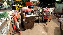 Pekerja memeriksa gerobak sampah mengantri di Tempat Pembuangan Sampah Sementara Kalibata, Jakarta, Senin (4/1/2016). Rencananya Pemda DKI Jakarta akan mengganti gerobak dengan sepeda motor yang dilengkapi dengan bak. (Liputan6.com/Helmi Fithriansyah)