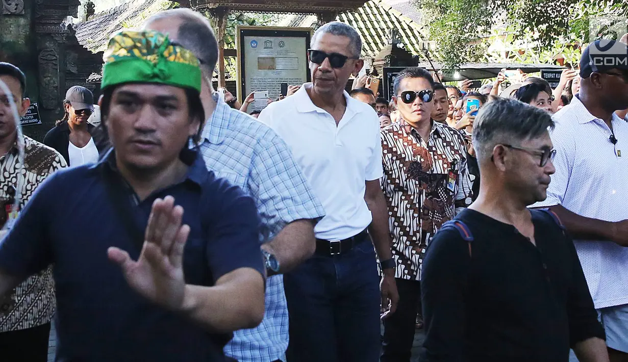 Mantan Presiden AS, Barack Obama dijaga ketat saat mengunjungi Pura Tirta Empul, Tampaksiring, Gianyar, Bali, Selasa (27/6). Kunjungan Obama tersebut mendapat sambutan antusias dari pengunjung yang memadati pura. (Liputan6.com/Immanuel Antonius)