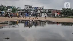 Anak-anak saat bermain di permukiman kumuh Muara Baru, Jakarta, Rabu (19/1/2022). Badan Pusat Statistik (BPS) mencatat angka kemiskinan di Indonesia turun menjadi 26,5 juta orang per September 2021 dari sebelumnya mencapai 27,54 juta orang pada Maret 2021. (merdeka.com/Iqbal S Nugroho)