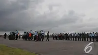 Sejumlah petugas berbaris di sisi landasan saat menyambut jenazah penumpang AirAsia QZ8501, Pangkalan Bun, Kalteng, Senin (5/1/2015). (Liputan6.com/Herman Zakharia)