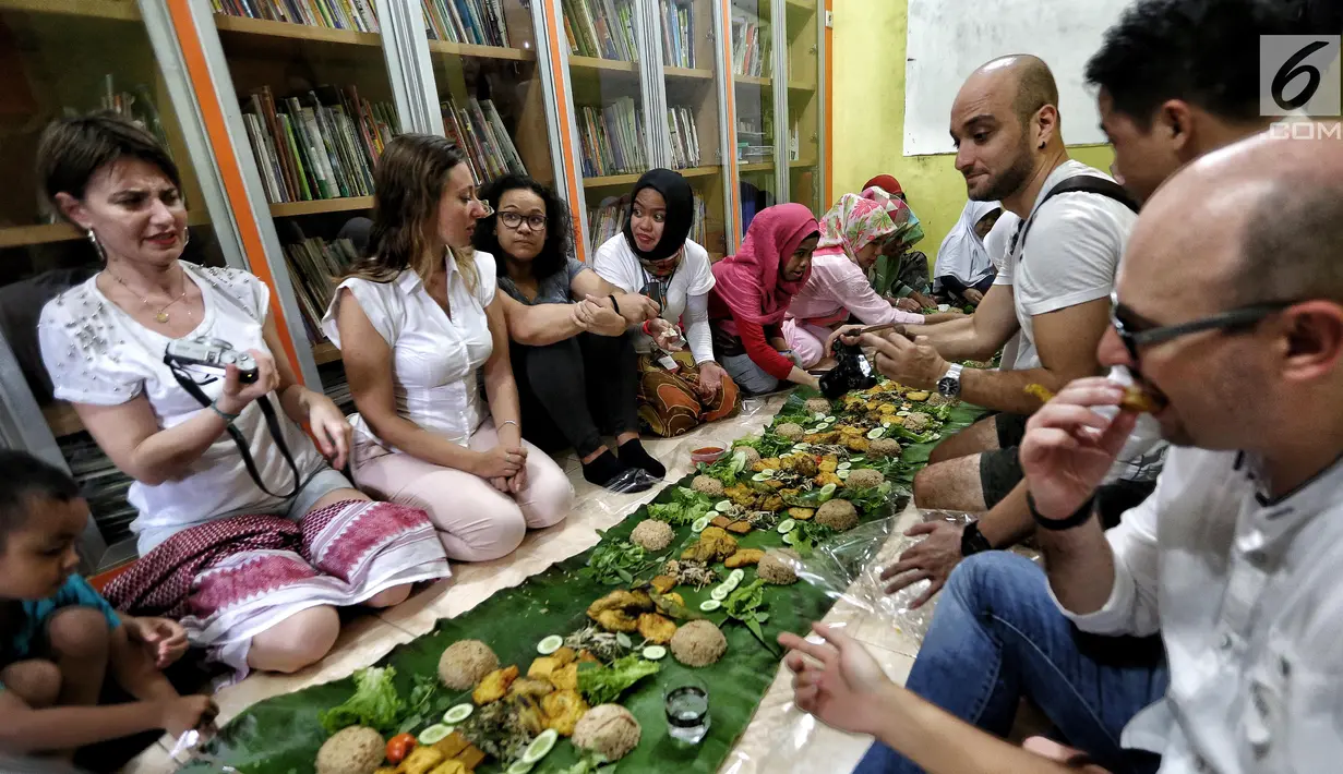 Sejumlah anak yatim, kaum dhuafa serta lima WNA menikmati makanan nasi liwet sambil lesehan di Rumah Amalia, Ciledug, Kota Tangerang, Sabtu (3/3). Komunitas couchsurfing Indonesia bertujuan membuka jendela pengetahuan anak-anak (Liputan6.com/Fery Pradolo)