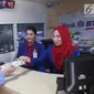 Seorang wanita menukarkan uang pecahan kecil pada mobil kas keliling Bank BTN di Lapangan IRTI Monas, Jakarta, Rabu (7/6). Bank Indonesia bekerja sama dengan 13 bank lainnya melayani penukaran uang hingga 16 Juni mendatang. (Liputan6.com/Angga Yuniar)