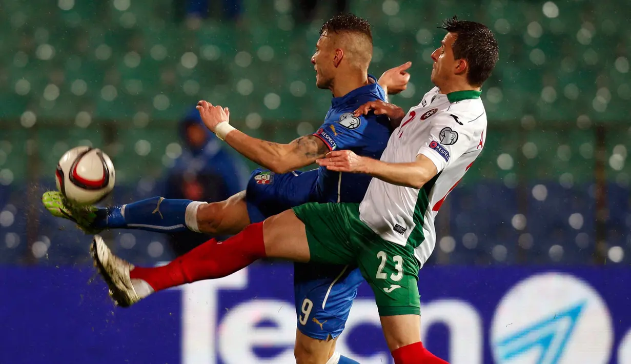 Penyerang  Italia, Ciro Immobile (kiri) berebut bola dengan bek Bulgaria Aleksandar Aleksandrov pada kualifikasi Piala Eropa 2016 di Stadion Nasional Vasil Levski, Minggu (29/3/2015). Italia bermain imbang 2-2 melawan Bulgaria. (REUTERS/Stoyan Nenov)