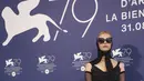 Mia Goth berpose untuk fotografer pada sesi pemotretan untuk film 'Pearl' selama V enice Film Festival 2022 ke-79 di Venesia, Italia, Sabtu (3/9/2022). Aktris Suspiria juga mengenakan sepasang sarung tangan hitam panjang dan satu set kaus kaki yang serasi. (Photo by Joel C Ryan/Invision/AP)