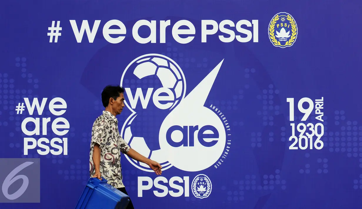 Seorang pria melintas di depan banner HUT PSSI ke-86 di Stadion GBK Jakarta, Selasa (19/4/2016). Setahun pasca dibekukan oleh Kemenpora, PSSI merayakan hari jadinya secara sederhana. (Liputan6.com/Helmi Fithriansyah)