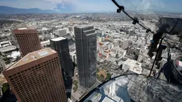 Suasana kota Los Angeles dari lantai 69 dan 70 Bank Tower AS menggunakan seluncuran skyslide, California, (20/6). Permainan yang cukup Ekstrem ini hanya diperuntukkan bagi orang tak takut ketinggian. (REUTERS / Lucy Nicholson)