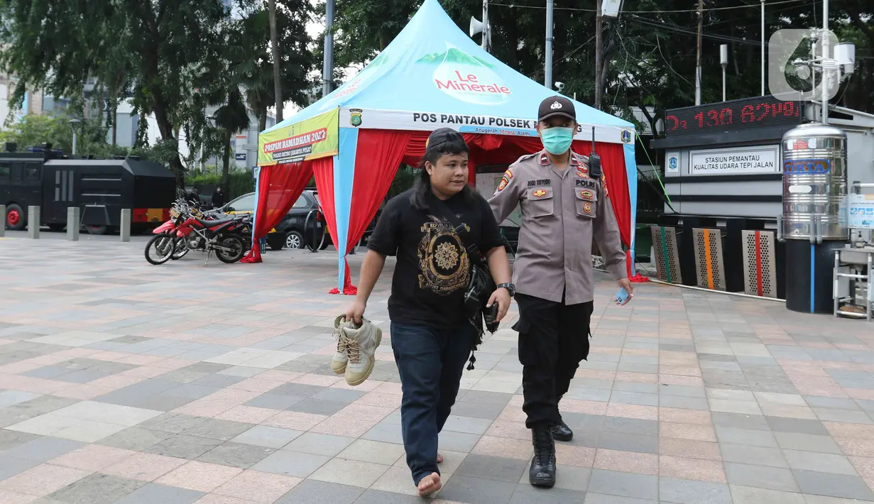 Petugas kepolisian mengamankan sejumlah oknum di kawasan Bundaran HI, Jakarta, Senin (11/4/2022).
Oknum tersebut diamankan karena diduga sebagai penyusup saat demo 11 April yang digelar oleh Badan Eksekutif Mahasiswa Seluruh Indonesia (BEM SI). (Liputan6.com/Herman Zakharia)