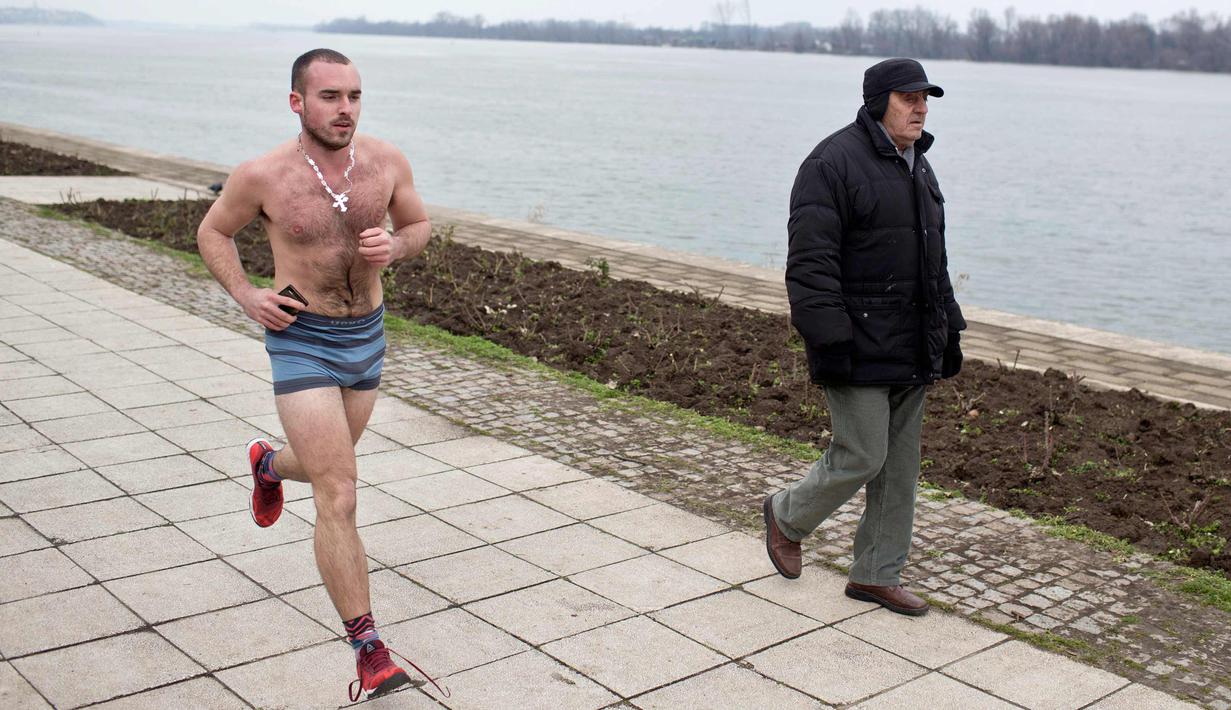 Seorang peserta pria mengikuti lomba Underpants Run di tepi sungai Danube di Beograd, Serbia (4/2). Dengan hanya mengenakan pakaian dalam para peserta tetap semangat mengikuti lomba dengan suhu mendekati nol derajat Celcius. (AP Photo/Marko Drobnjakovic)