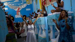 Narapidana wanita beragam kostum tampil dalam acara Natal tahunan di Penjara Nelson Hungria, Rio de Janeiro, Brasil, Kamis (13/12). Para narapidana sedang menjalani hukuman karena pelanggaran perampokan hingga pembunuhan. (AP Photo/Silvia Izquierdo)