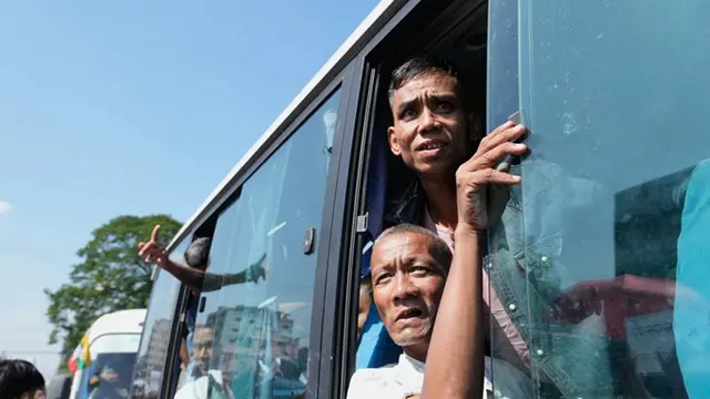Para tahanan yang dibebaskan, berada di dalam bus, disambut oleh anggota keluarga dan rekan-rekan mereka setelah meninggalkan Penjara Insein pada Minggu (4/1/2026), di Yangon, Myanmar.