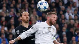 Penyerang Paris St Germain, Zlatan Ibrahimovic (kiri) berebut bola udara dengan bek Real Madrid, Sergio Ramos pada liga champions di stadion Santiago Bernabeu, Madrid, Spanyol (3/11). Real Madrid menang atas PSG dengan skor 1-0. (Reuters/Juan Medina)