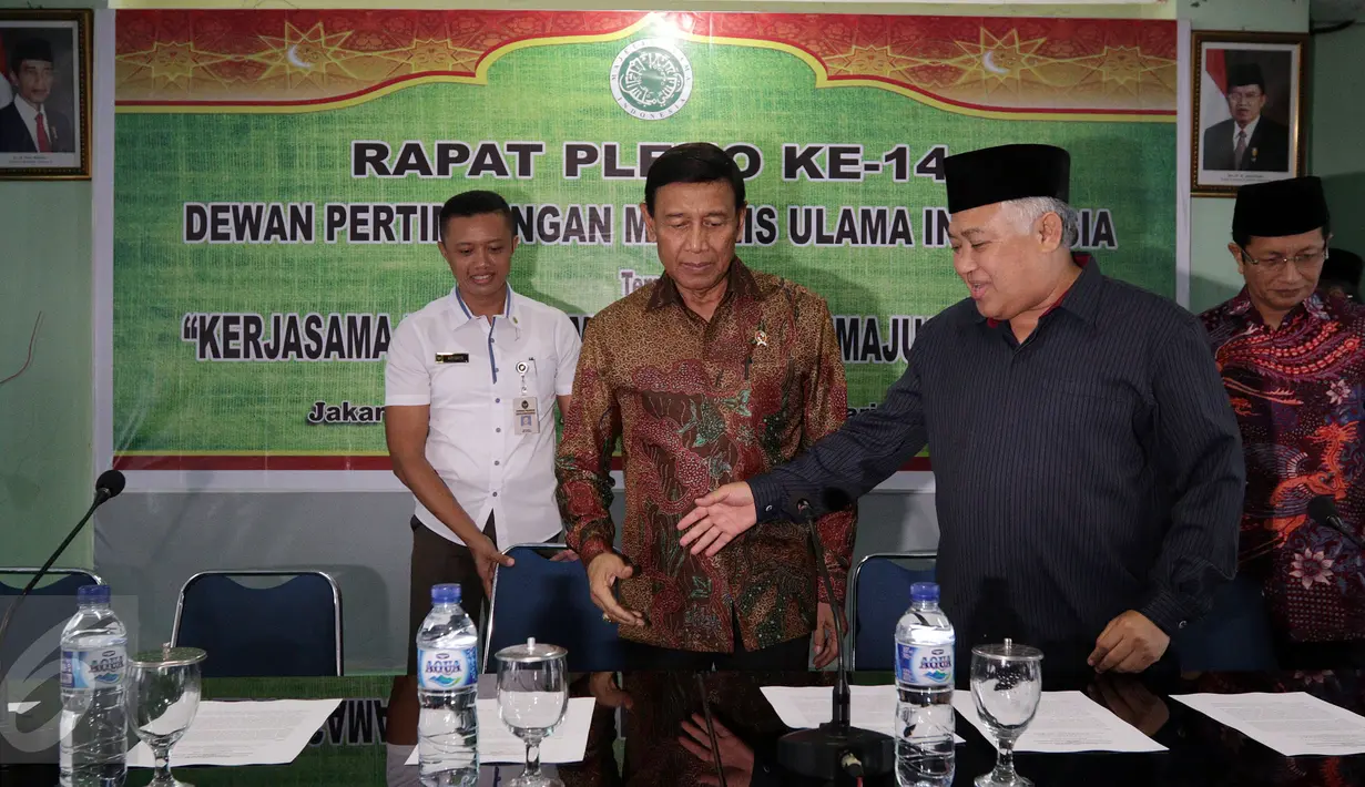 Ketua Dewan Pertimbangan Majelis Ulama Indonesia (MUI) Pusat, Din Syamsuddin mempersilahkan Menko Polhukam Wiranto untuk duduk jelang konferensi pers di Gedung MUI, Jakarta Rabu (18/1). (Liputan6.com/Johan Tallo)