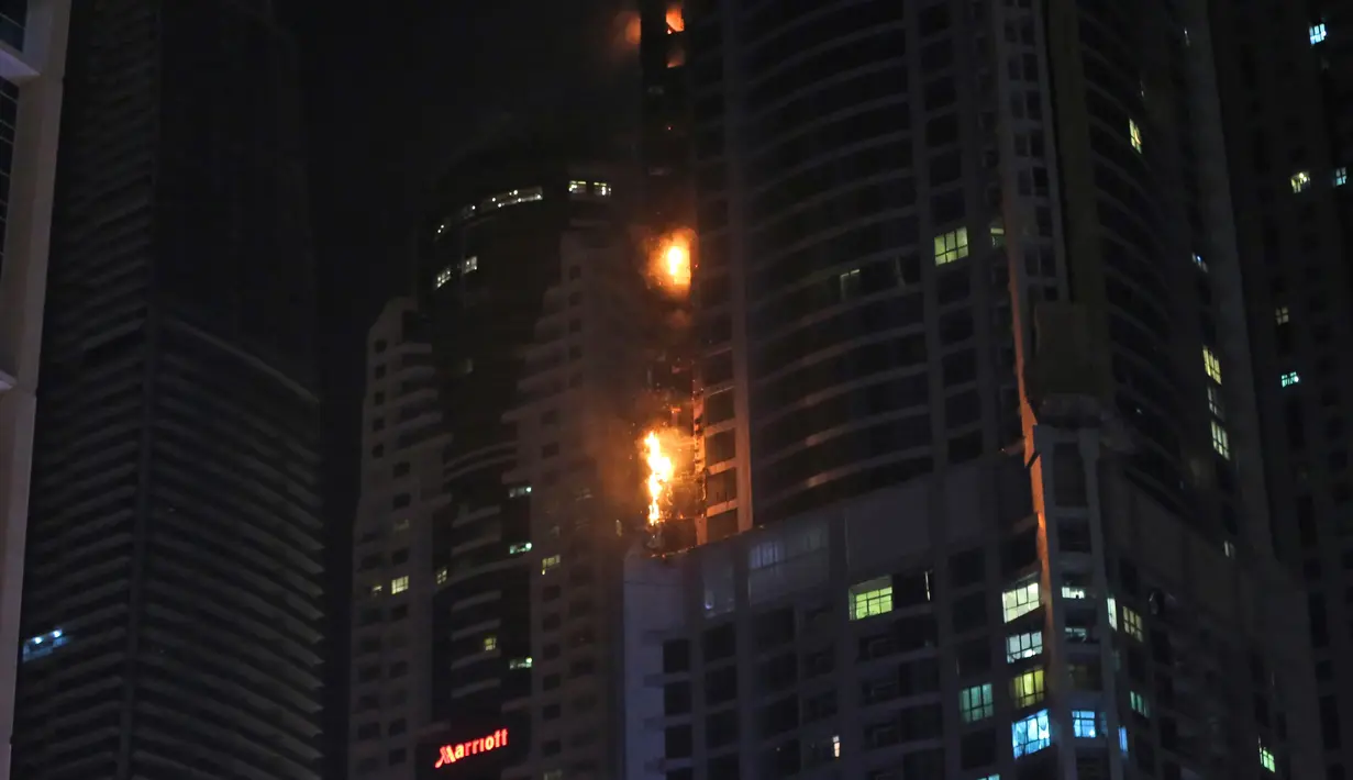 Kobaran api melalap Menara Torch, sebuah gedung hunian setinggi 330 meter di Dubai, Uni Emirat Arab, Jumat (4/8/) pagi. Pihak berwenang mengatakan bahwa gedung itu berhasil dievakuasi dan petugas darurat mencoba mengendalikan api. (AP/Kamran Jebreili)