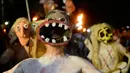 Peserta dengan memakai topeng bersuka ria mengikuti parade " La Calabiuza " di El Savador, Minggu (1/11/2015). Acara ini dirayakan oleh warga Tonacatepeque yang berada di Utara El Savador. (AFP PHOTO/Marvin RECINOS)