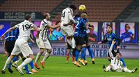 Gelandang Juventus, Weston McKennie (tengah) menanduk bola ke gawang Inter Milan dalam laga lanjutan Liga Italia Serie A 2020/21 pekan ke-18 di San Siro Stadium, Minggu (17/1/2021). Juventus kalah 0-2 dari Inter Milan. (AFP/Miguel Medina)