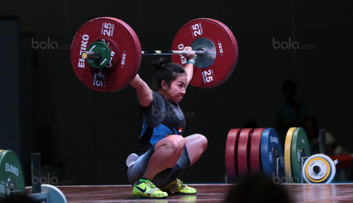 Ekspresi Dewi Safitri saat turun pada kelas 53 kg di Hall A Arena Pekan Raya Jakarta, Kemayoran, Rabu (11/2/2018). Dewi Safitri menang dengan total angkatan 184 kg. (Bola.com/Nicklas Hanoatubun)
