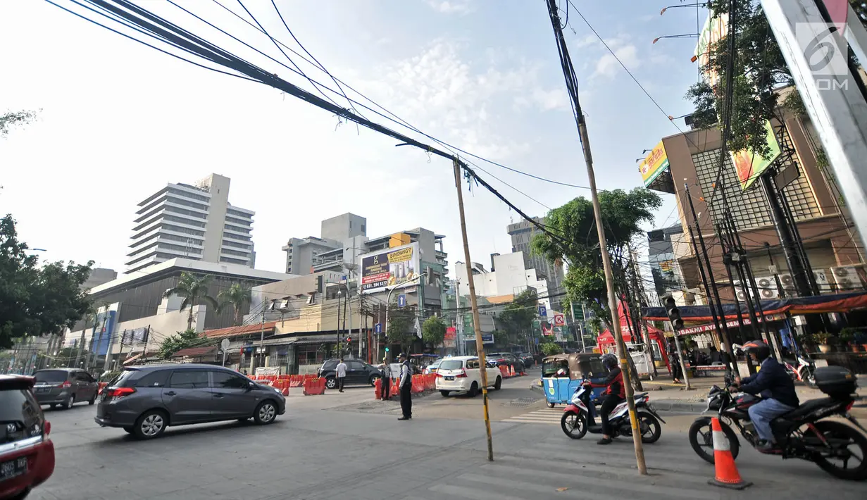 Kendaraan saat melintasi bambu penyangga kabel di Jalan Wahid Hasyim, Jakarta, Selasa (6/11). Dua buah bambu penyangga kabel tersebut mengganggu kenyamanan dan mengancam keselamatan pengguna jalan. (Merdeka.com/Iqbal S. Nugroho)