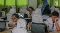 Sejumlah siswa mengikuti Ujian Nasional Berbasis Komputer (UNBK) di SMP Negeri (SMPN) 1, Cikini, Jakarta, Senin, (22/4). Sebanyak 4.279.008 siswa mengikuti UNBK tingkat SMP dan Madrasah Tsanawiyah (MTS) yang dilaksanakan mulai 22 April hingga 25 April. (Liputan6.com/Faizal Fanani)