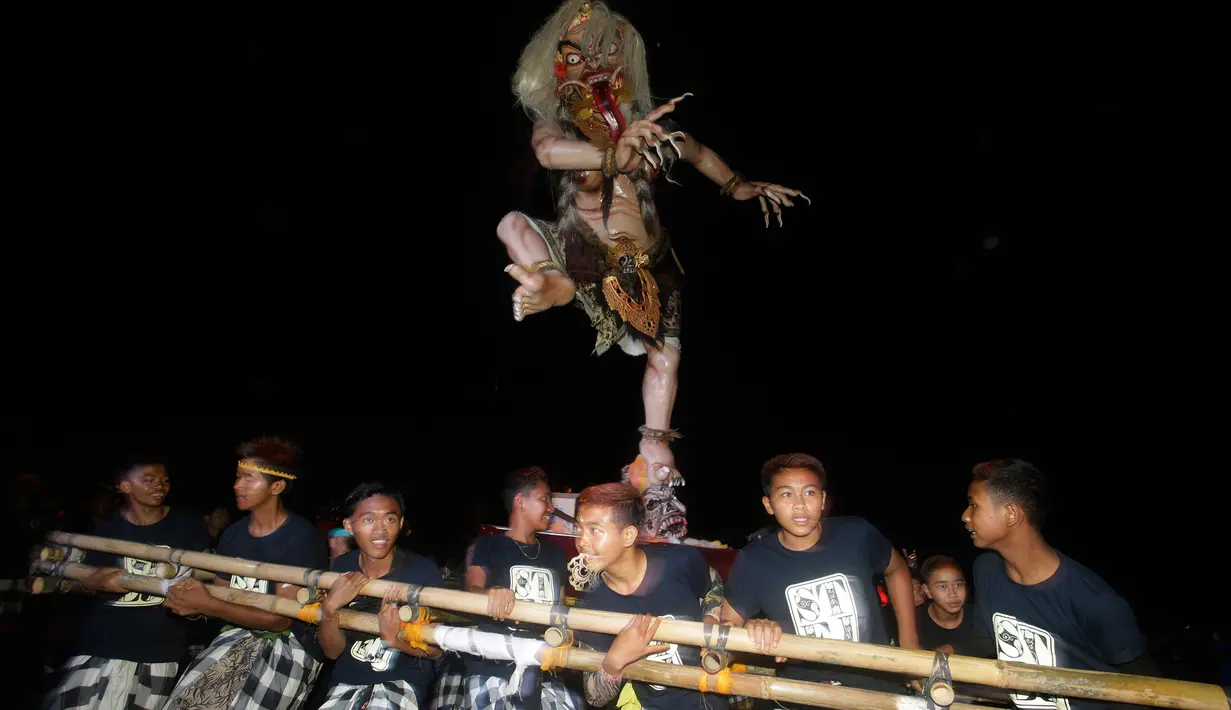 Sejumlah pemuda mengarak Ogoh-Ogoh atau boneka raksasa menjelang Hari Raya Nyepi Tahun Saka 1940 di Bali, Kamis (15/3). Pelaksanaan pawai ogoh-ogoh berlangsung serempak sehari menjelang Hari Raya Nyepi di setiap banjar seluruh Bali. (AP/Firdia Lisnawati)