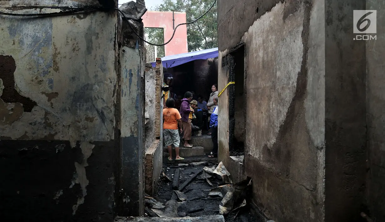 Warga berada di sisa rumah pasca kebakaran yang melahap permukiman di Jalan Kebon Sayur, Bidara Cina, Jakarta, Minggu (27/5). Sedikitnya 43 rumah warga di RT 007 dan 008 RW 014 di Bidara Cina ludes dilalap api. (Merdeka.com/Iqbal S Nugroho)