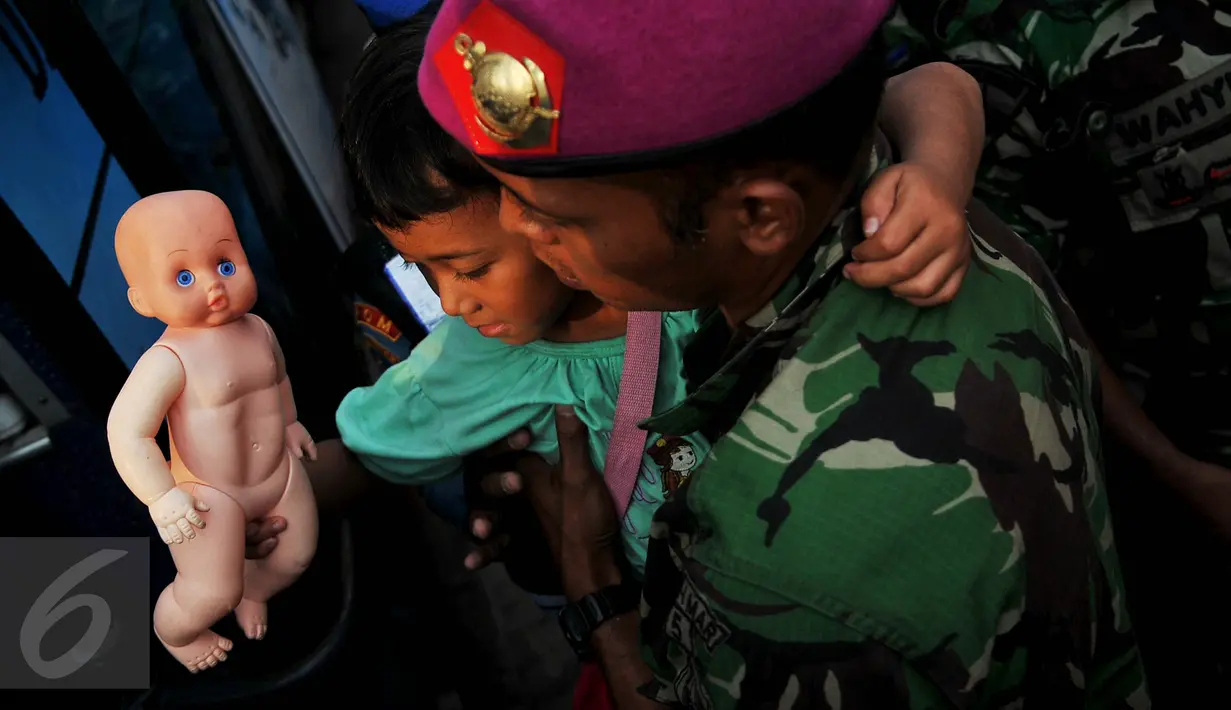 Seorang anggota TNI AD menggendong bocah dari salah satu keluarga eks Gerakan Fajar Nusantara (Gafatar) turun dari KRI Teluk Bone 551 menuju bus jemputan di Dermaga JITC 2 Pelabuhan Tanjung Priok, Jakarta, Kamis (28/1/2016). (Liputan6.com/Gempur M Surya)