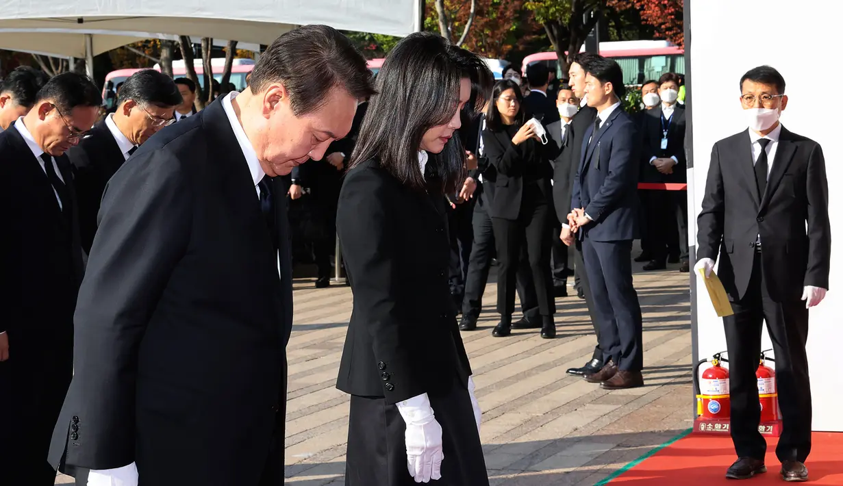 Presiden Korea Selatan Yoon Suk-yeol dan istrinya Kim Keon-hee memberikan penghormatan untuk para korban tragedi Halloween Itaewon di altar peringatan bersama di Seoul Square, Seoul, Korea Selatan, Senin (31/10/2022). Tragedi Halloween Itaewon menewaskan lebih dari 150 orang dan menjadi bencana terburuk Korea Selatan dalam beberapa tahun. (Ahn Jung-hwan/Yonhap via AP)