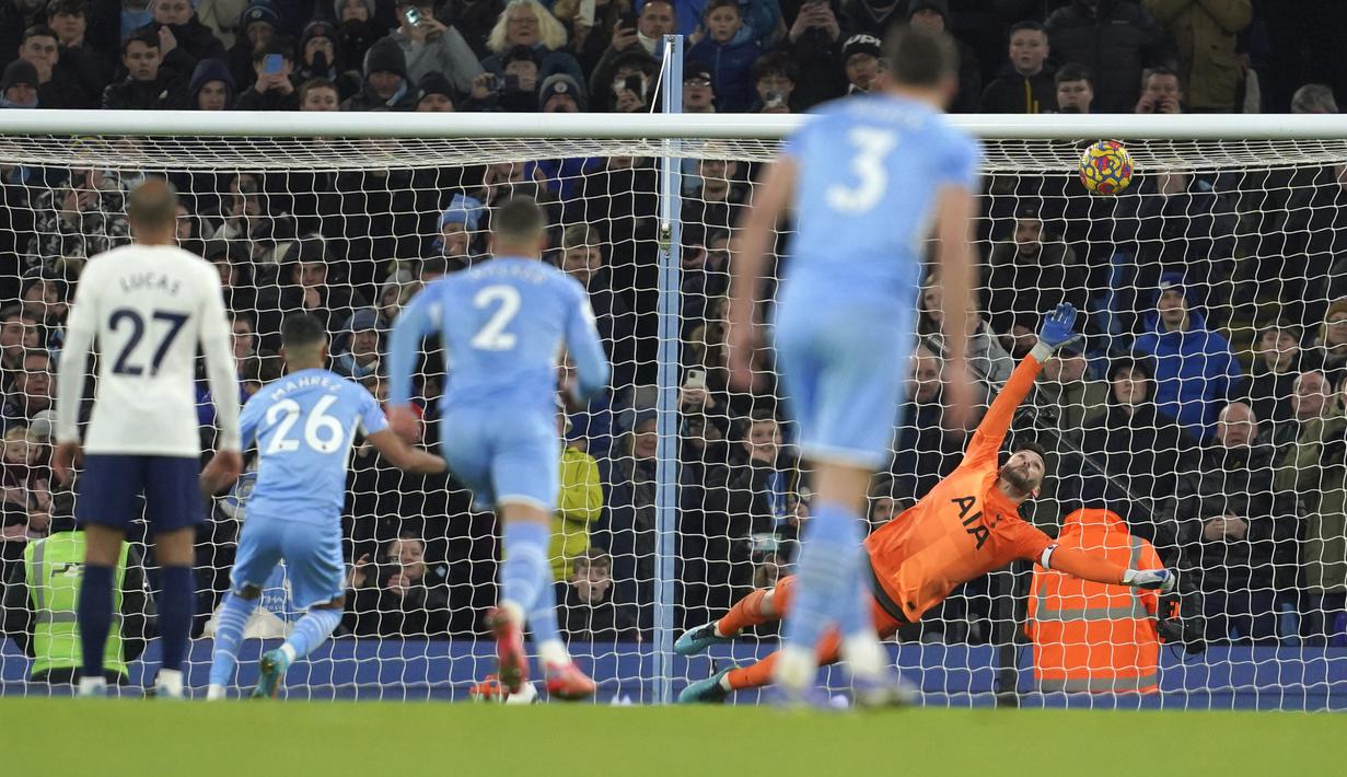 Saat laga memasuki menit kedua injury time, Man City mendapat hadiah penalti usai bek Tottenham Hotspur, Cristian Romero dianggap handball di dalam kotak penalti. Eksekusi yang diambil Riyad Mahrez berjalan mulus dan mengubah skor menjadi 2-2. (AP/Jon Super)