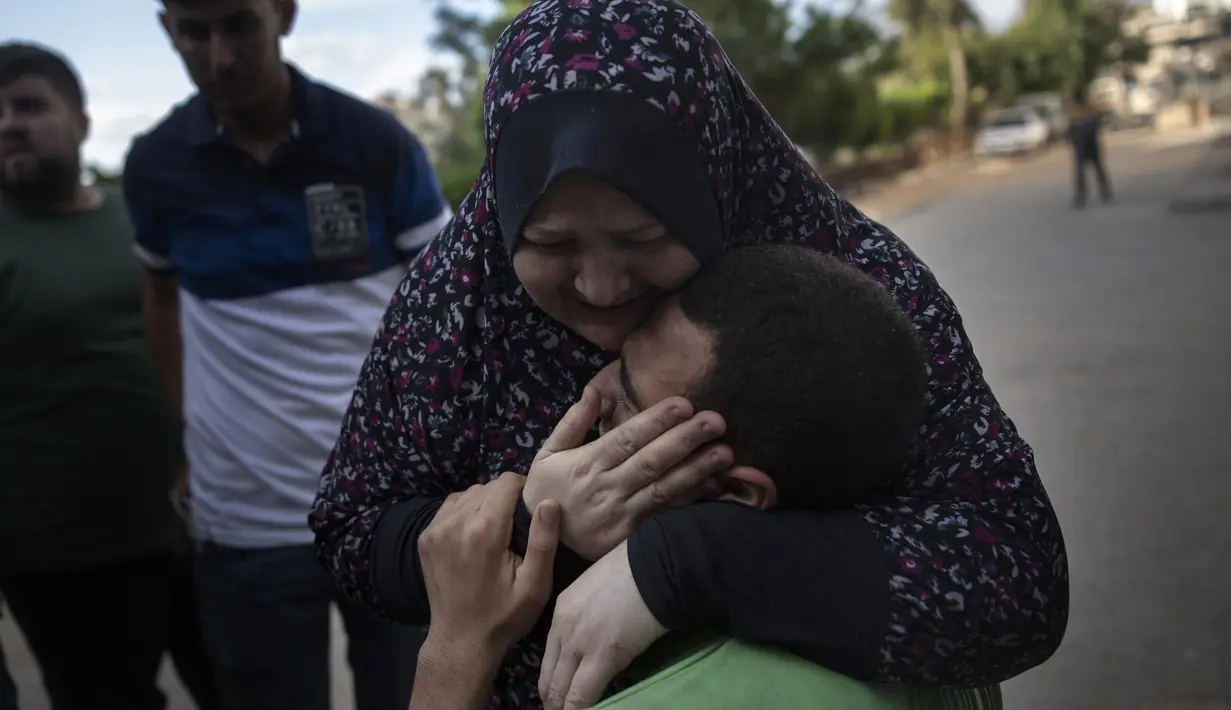 Kerabat bereaksi terhadap kematian seorang pria yang tewas dalam serangan udara Israel yang menghancurkan lantai atas sebuah bangunan komersial di Kota Gaza, Senin (17/5/2021). Tercatat ada 212 warga Palestina kehilangan nyawa di antaranya 61 korban merupakan anak-anak. (AP Photo/Khalil Hamra)