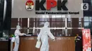 Petugas menyemprotkan cairan disinfektan di Gedung KPK, Jakarta, Selasa (22/9/2020). Penyemprotan dilakukan secara rutin untuk mengantisipasi serta menekan penyebaran virus COVID-19 menyusul temuan sedikitnya 21 kantor kementerian/lembaga yang menjadi klaster baru. (Liputan6.com/Helmi Fithriansyah)