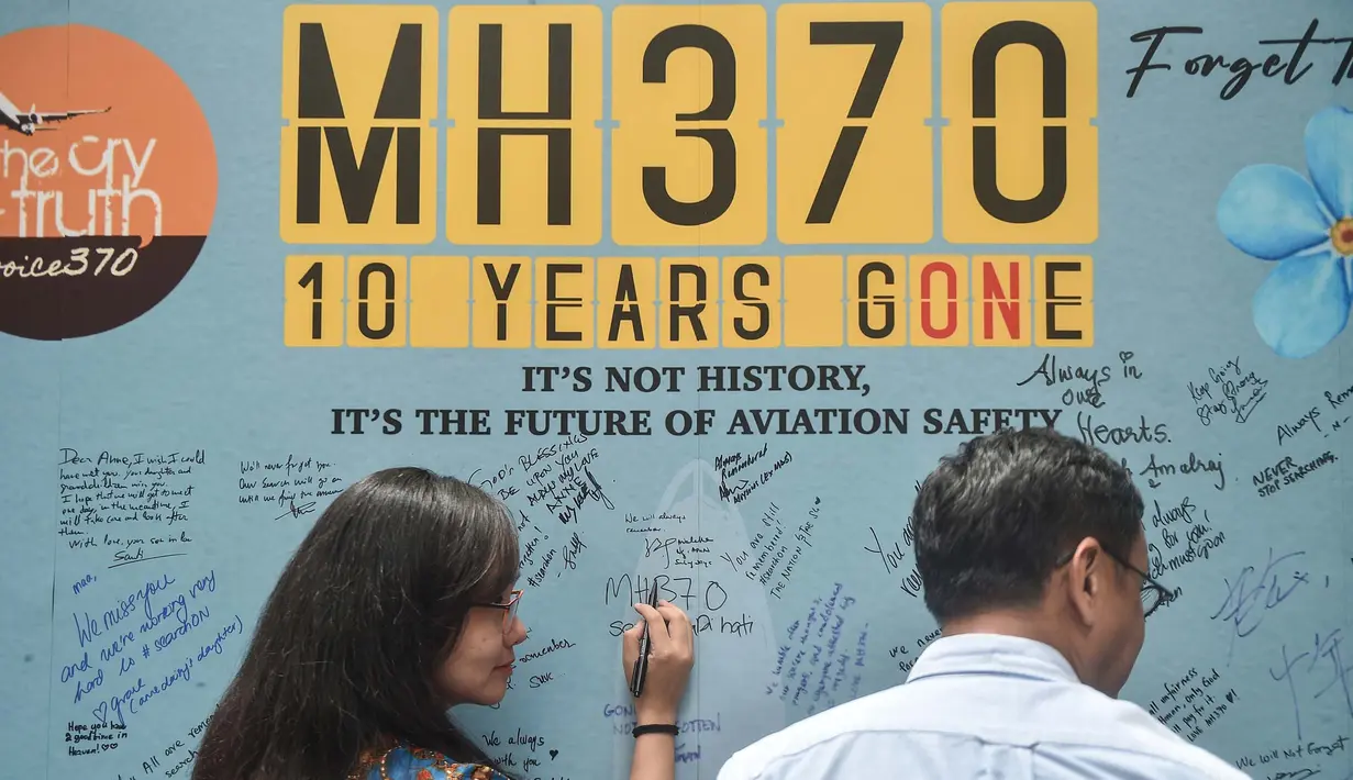 Seorang wanita menulis pesan dalam peringatan 10 tahun menghilangnya pesawat Malaysia Airlines dalam perjalanan dari Kuala Lumpur menuju Beijing, di Subang Jaya, pada tanggal 3 Maret 2024. (Arif Kartono/AFP)