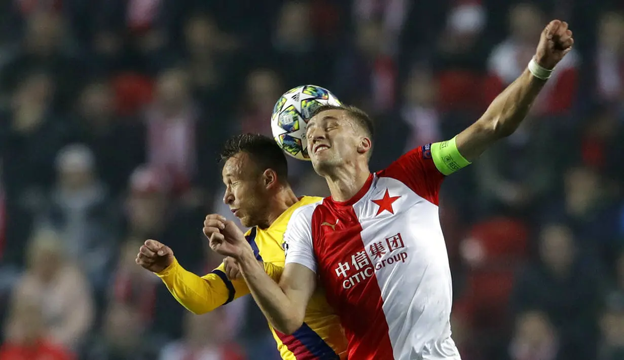 Bek Barcelona, Arthur, duel udara dengan pemain Slavia Praha, Tomas Soucek, pada laga Liga Champions 2019 di Stadion Sinobo, Rabu (23/10). Barcelona menang 2-1 atas Slavia Praha. (AP/Petr David Josek)