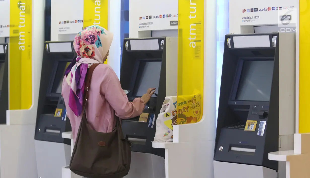 Pengunjung melakukan penarikan uang melalui ATM di kawasan Jakarta, Jumat (25/1). Hingga 2018 sendiri, kartu debit Mandiri yang beredar telah mencapai 18,7 juta keping. (Liputan6.com/Angga Yuniar)