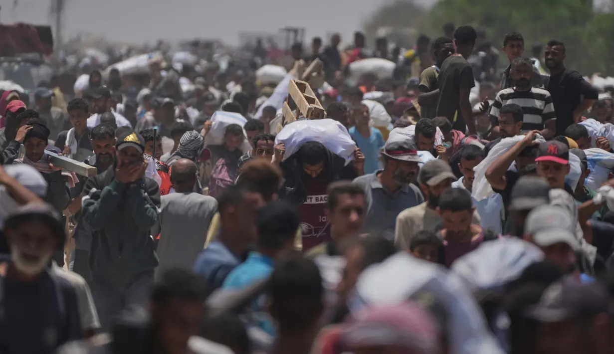 Warga Palestina membawa tas berisi makanan dan paket bantuan kemanusiaan yang dikirim oleh Yayasan Kemanusiaan Gaza (Gaza Humanitarian Foundation-GHF), sebuah organisasi yang didukung oleh Amerika Serikat, di Rafah, Jalur Gaza Selatan, Senin 9 Juni 2025. (AP Photo/Abdel Kareem Hana)