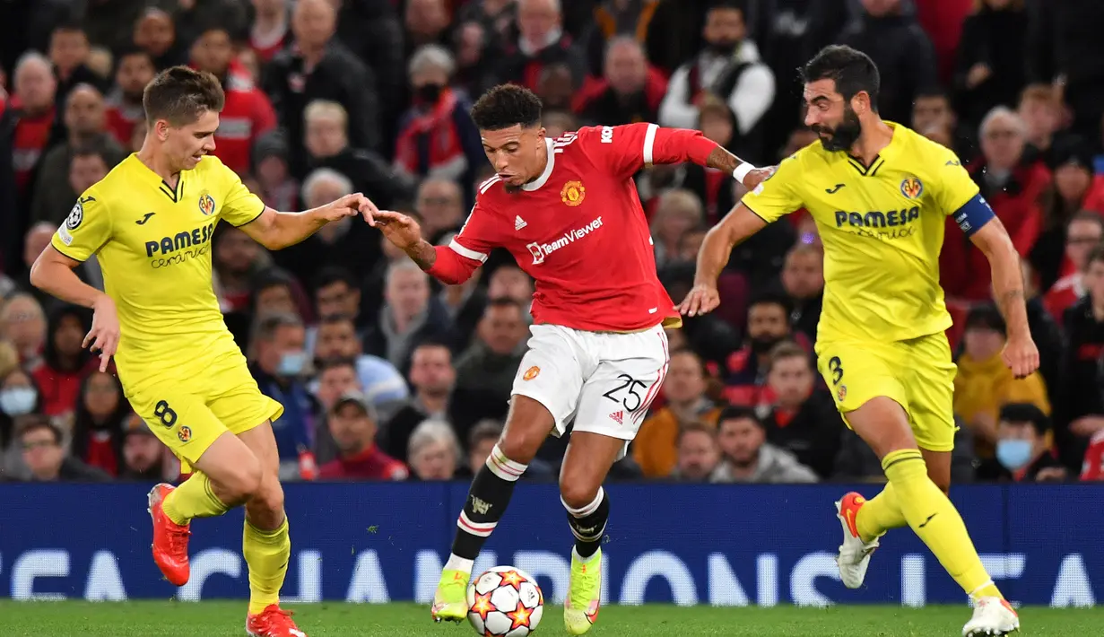 Bek Villarreal, Juan Foyth (kiri) dan Raul Albiol (kanan) berusaha merebut bola gelandang Manchester United, Jadon Sancho pada pertandingan grup F Liga Champions di Old Trafford, Inggris, Kamis (30/9/2021). Kemenangan atas Villarreal membuat MU berada di posisi kedua klasemen. (AFP/Anthony Devlin)