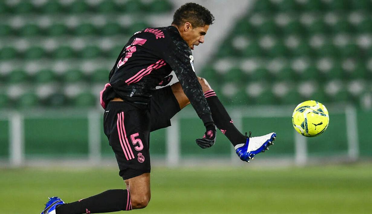 Bek Real Madrid, Raphael Varane, mengontrol bola saat melawan Elche pada laga Liga Spanyol di Stadion Manuel Martinez Valero, Rabu (30/12/2020). Kedua tim bermain imbang 1-1. (AP/Jose Breton)